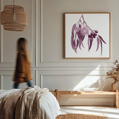 Modern bedroom with a person walking by, framed artwork on the wall, and a vase with dried plants.
